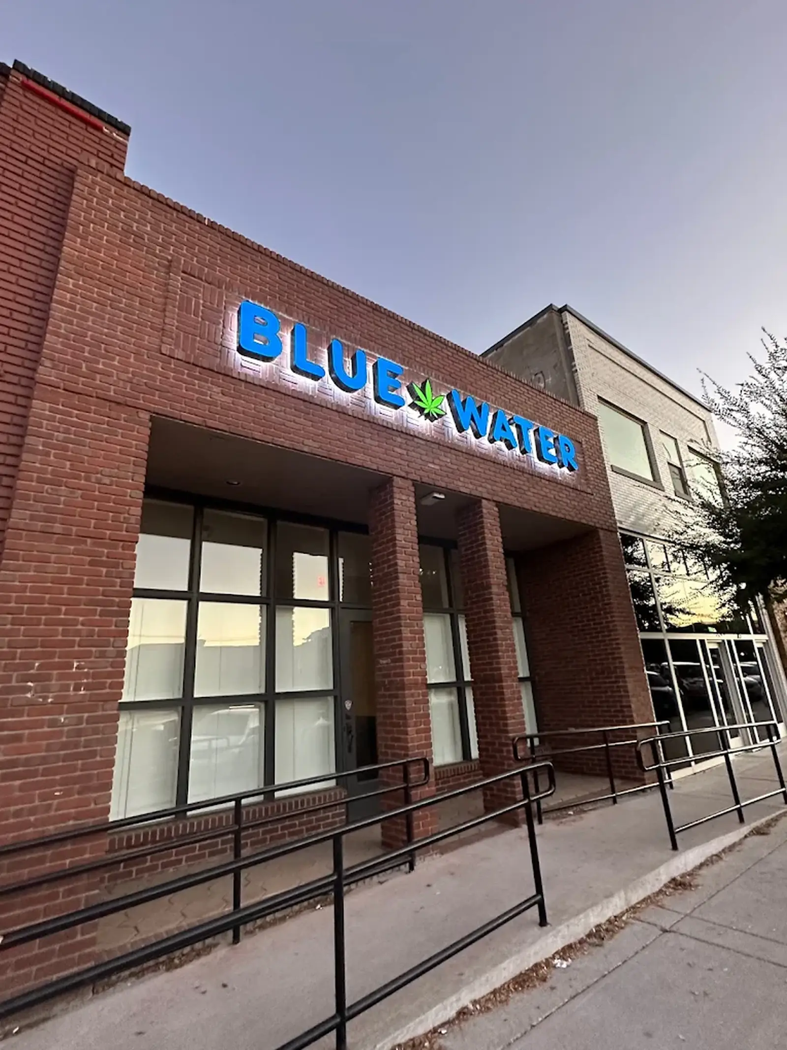 Blue Water Dispensary storefront sign on a brick building in Norman, OK